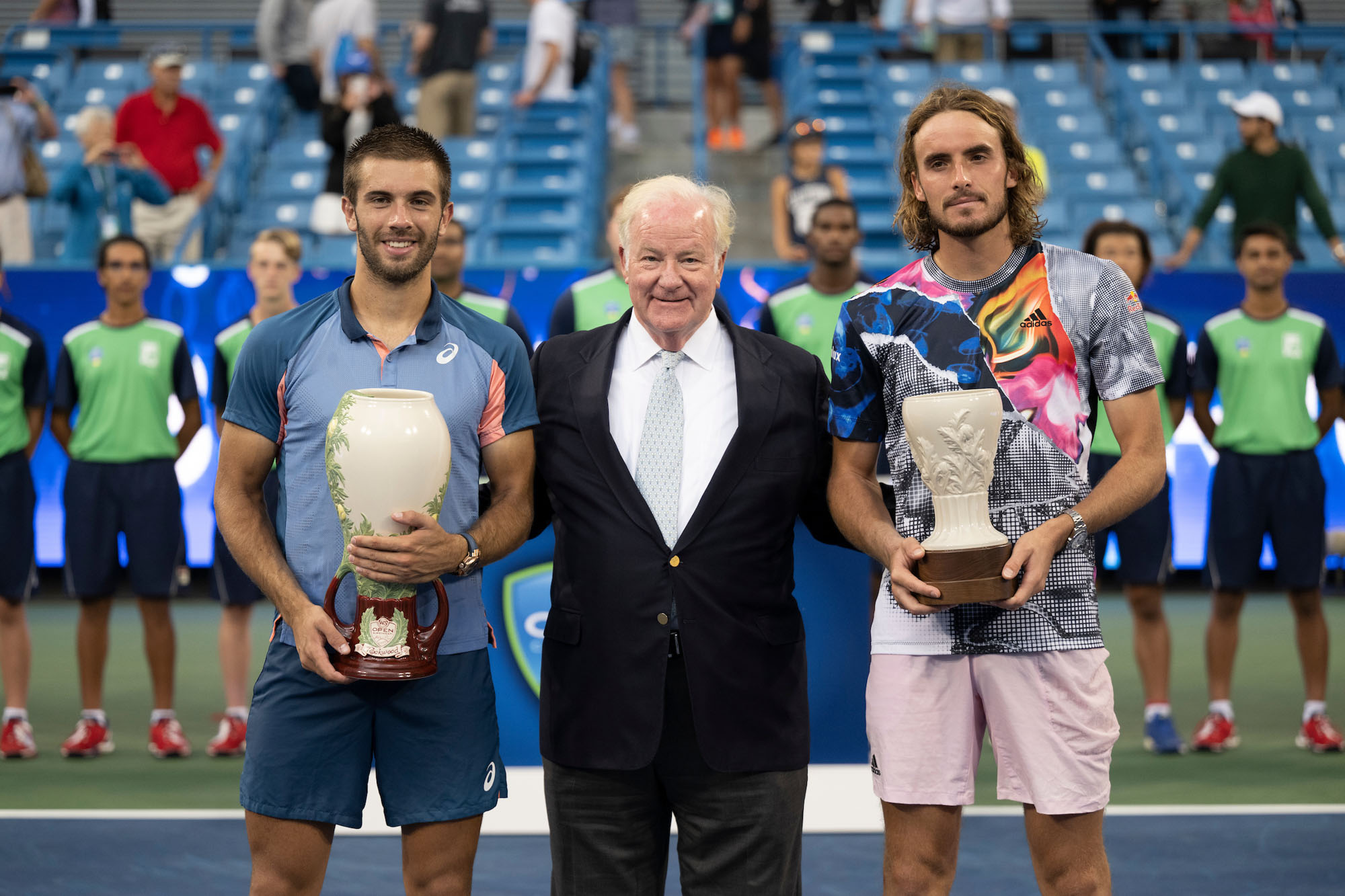 players with trophies on court