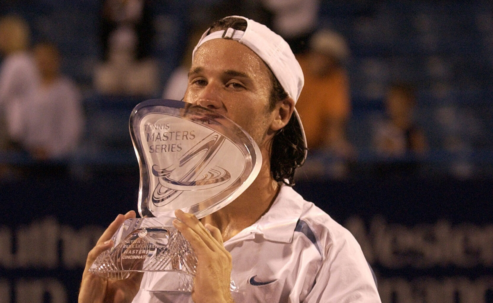 man kissing trophy