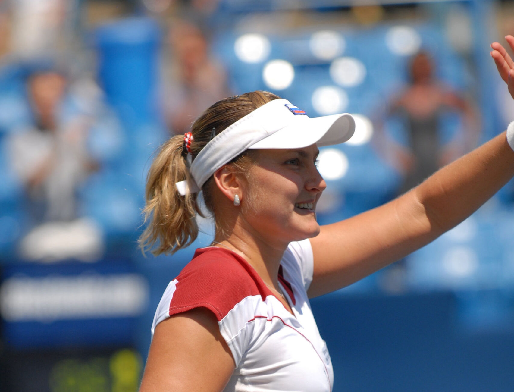 woman waving at tennis stadium