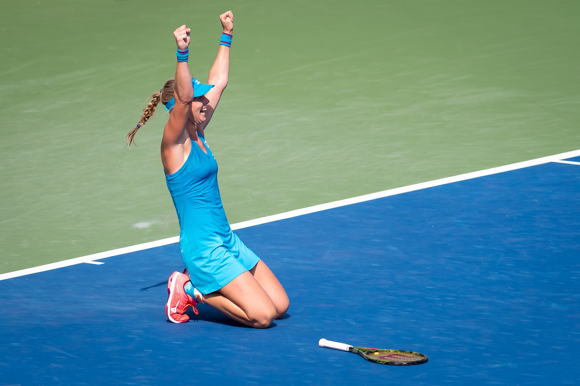 woman celebrating on the tennis court