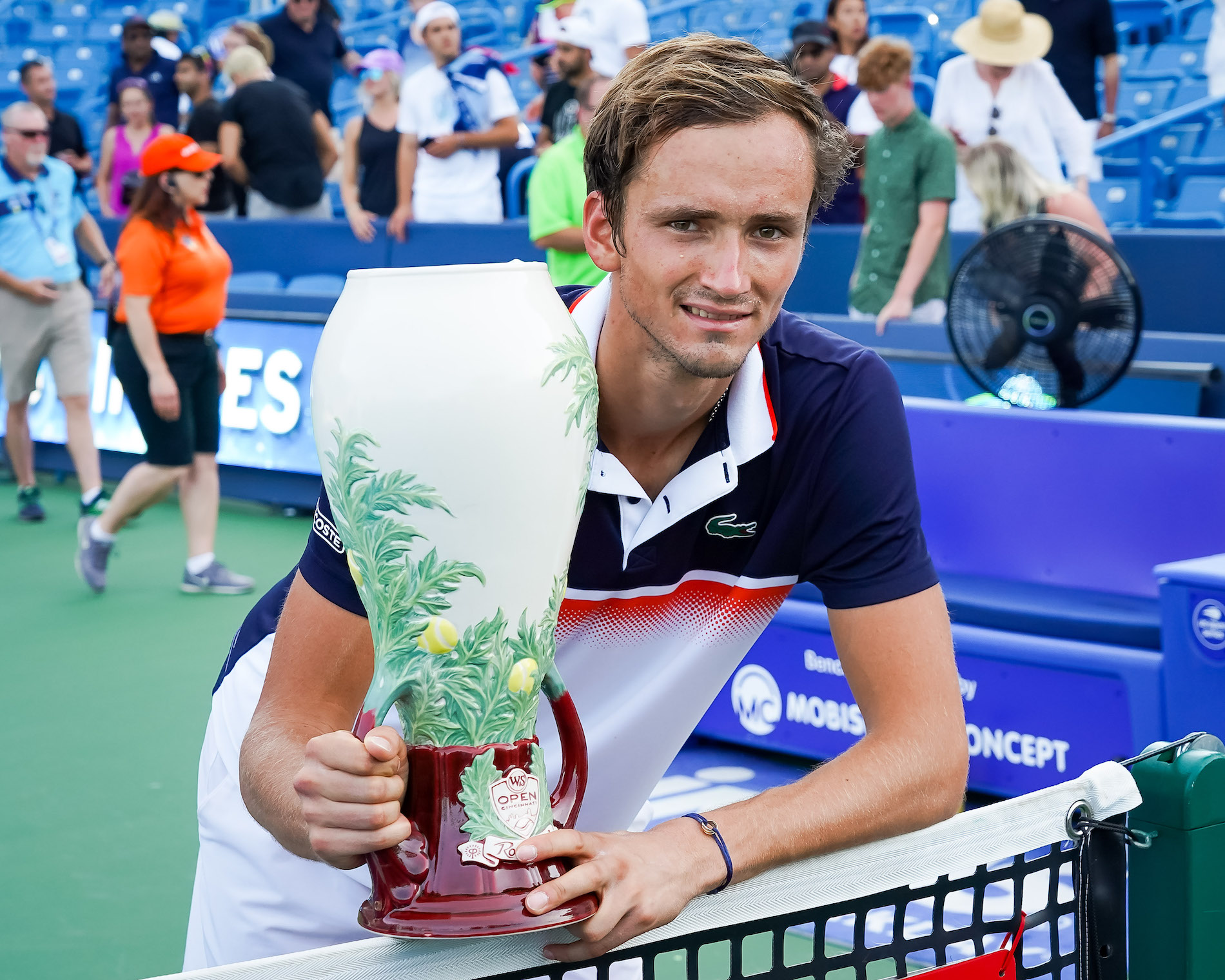man posing with trophy
