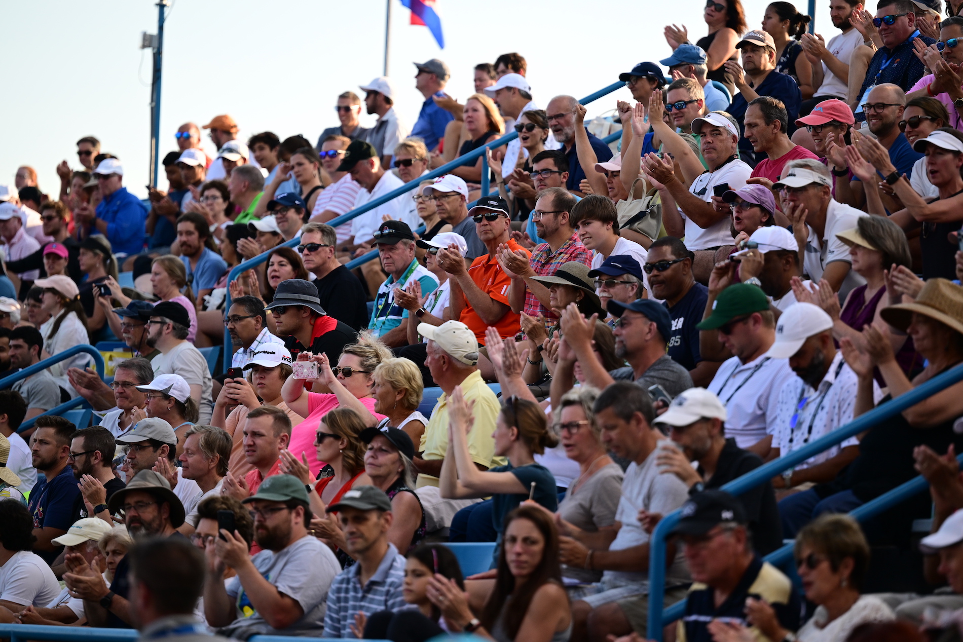 fans in the stands at tennis match