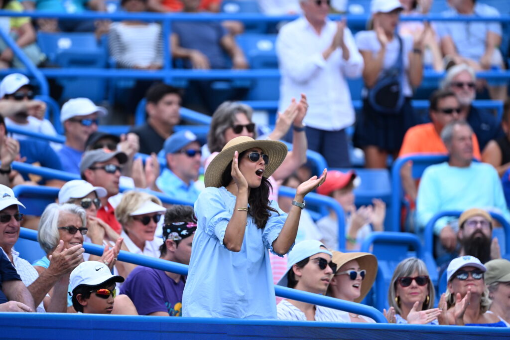 A fan yelling and clapping in the stands