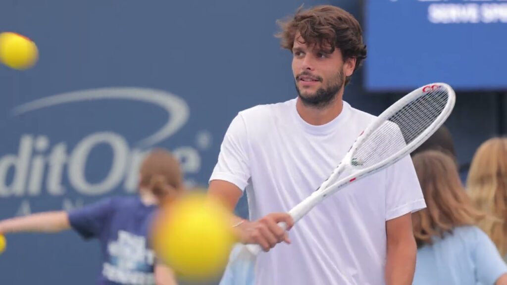 Player holding a tennis racket.