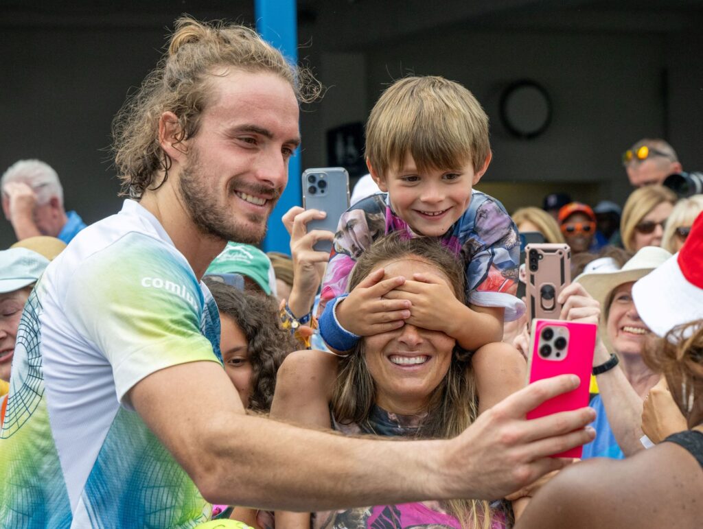 Stefanos Tsitsipas takes a selfie with fans