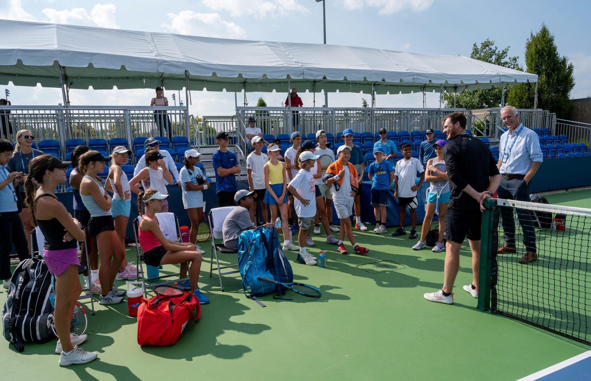 Todd Martin and Michael Venus talk to a group of kids