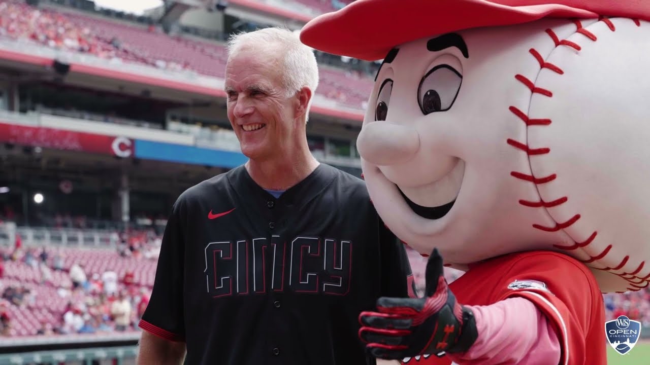 Todd Martin smiles with the Cincinnati Reds mascot.