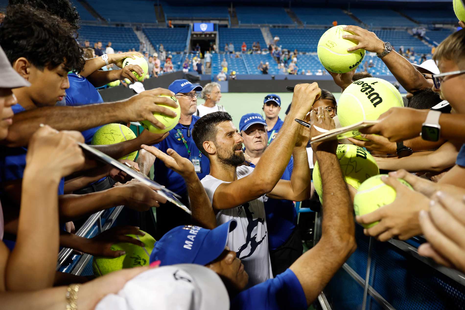 Novak Djokovic autographing balls