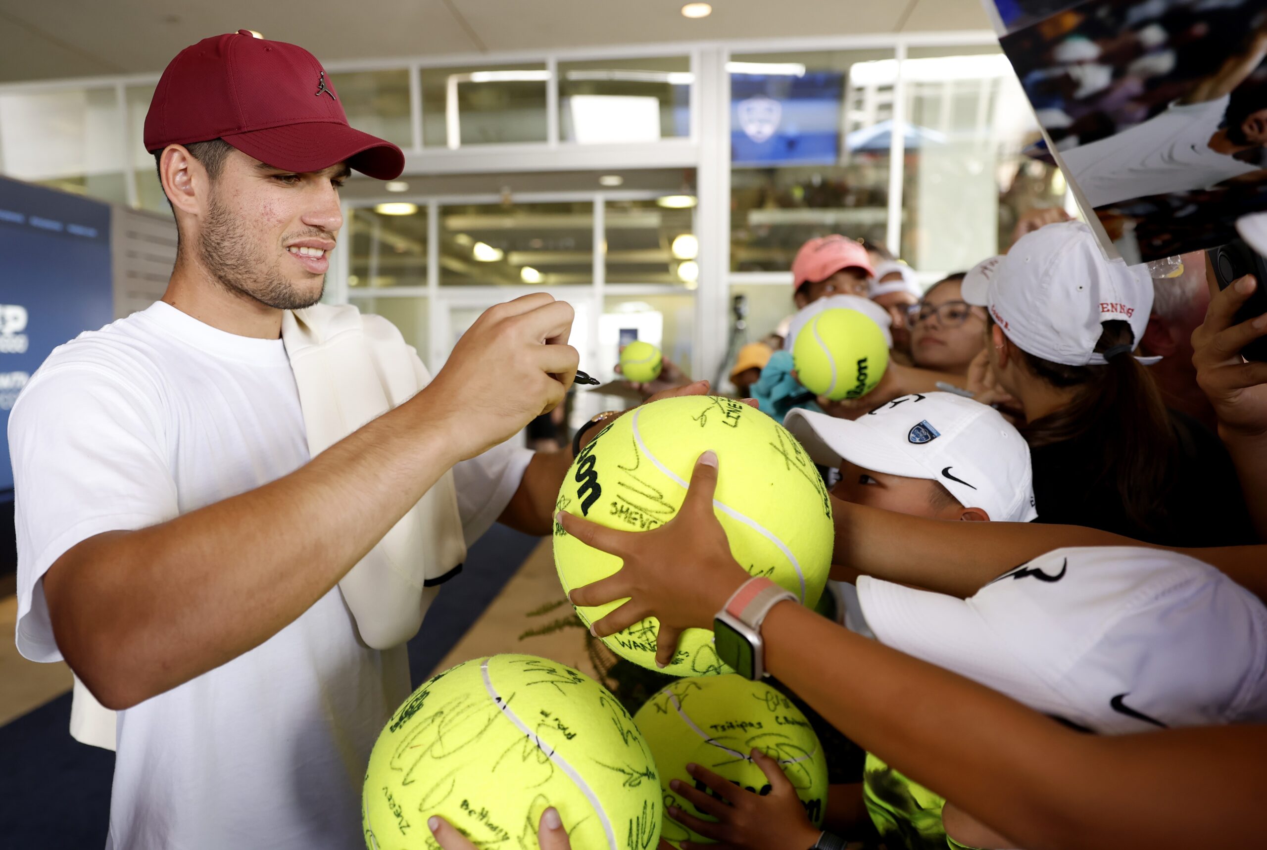 Carlos Alcaraz signing tennis balls
